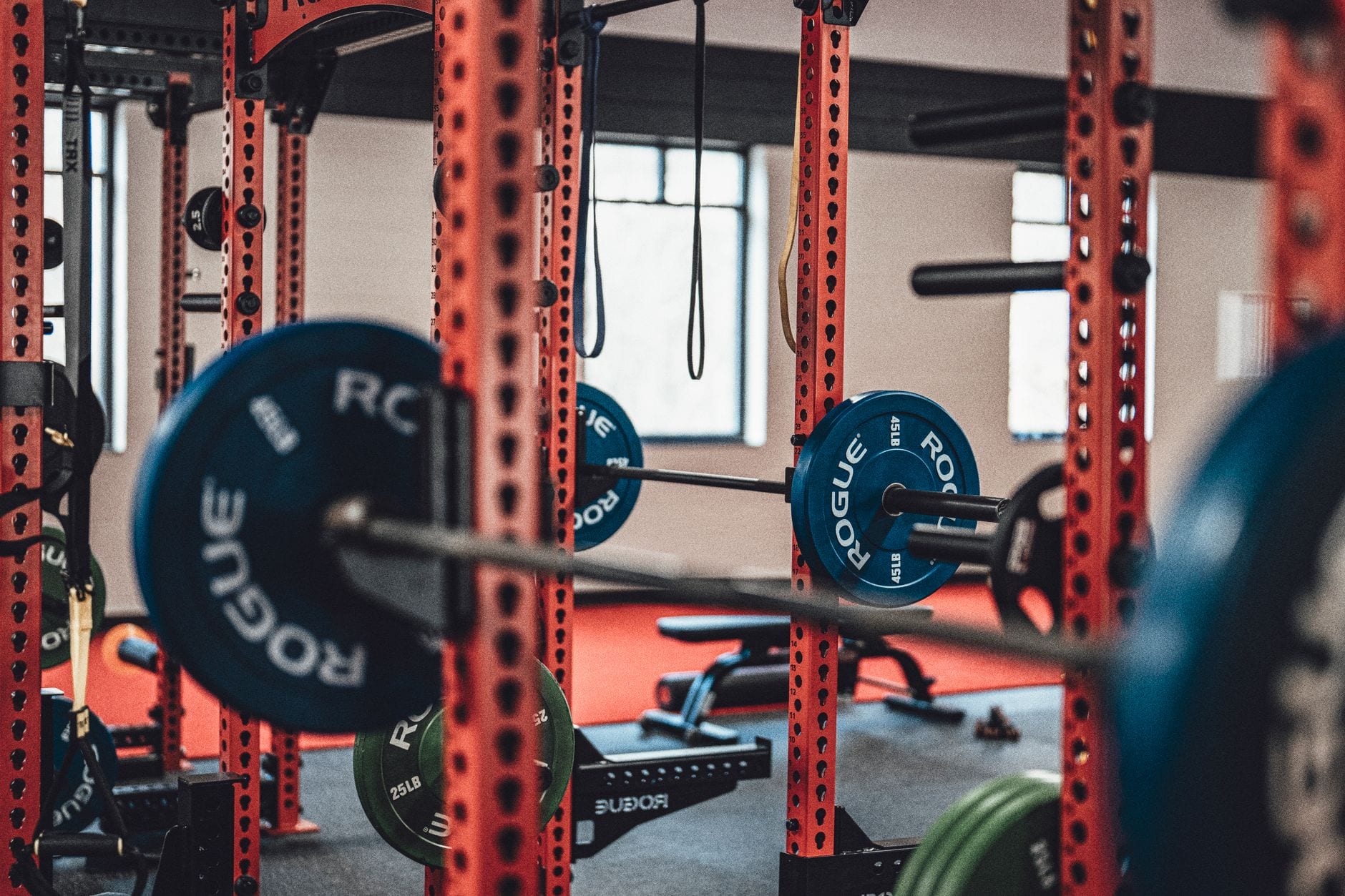 A lifter loading a barbell at the gym